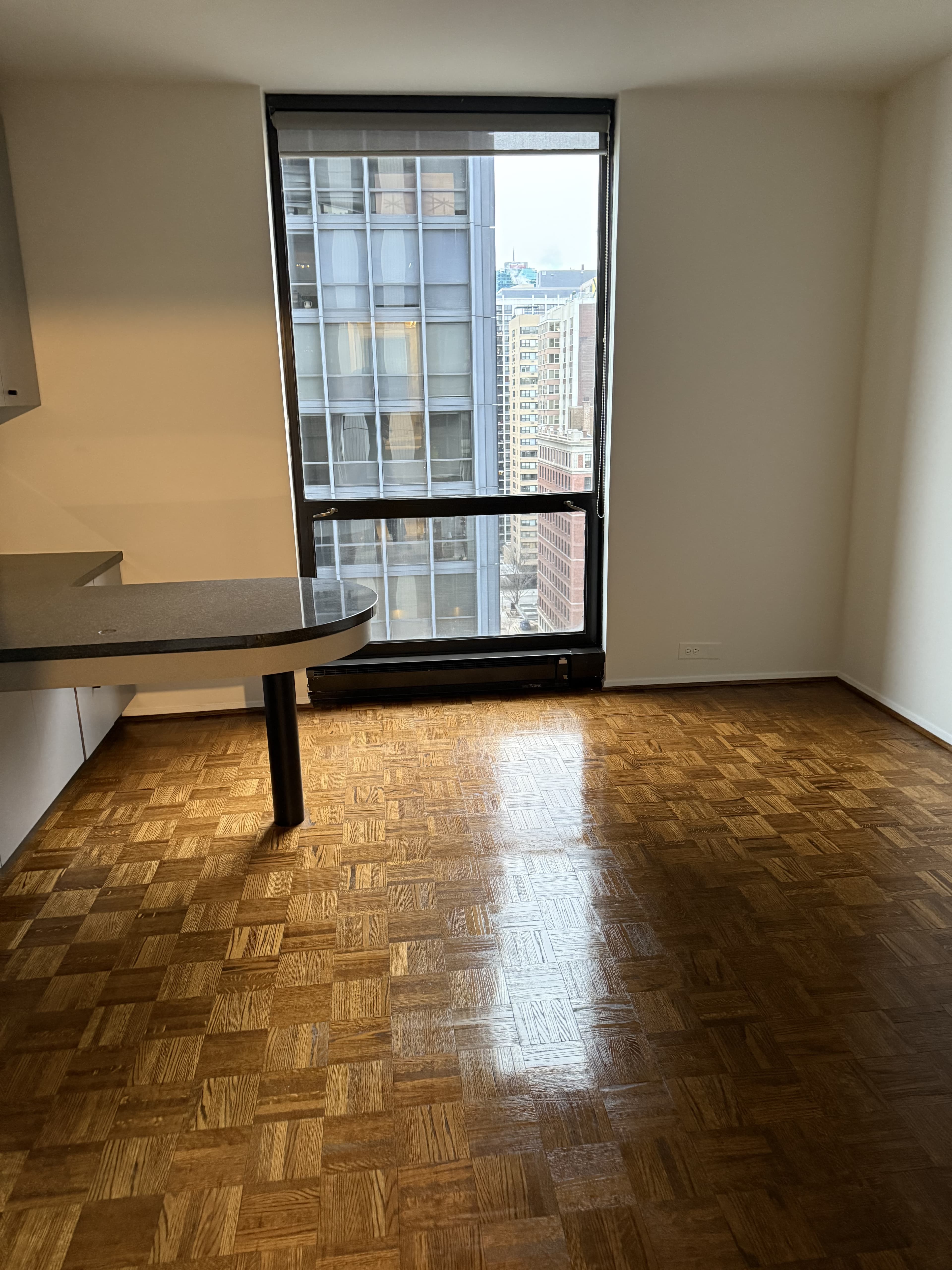 Empty apartment with spotless parquet floors after professional move-out cleaning in Joliet IL