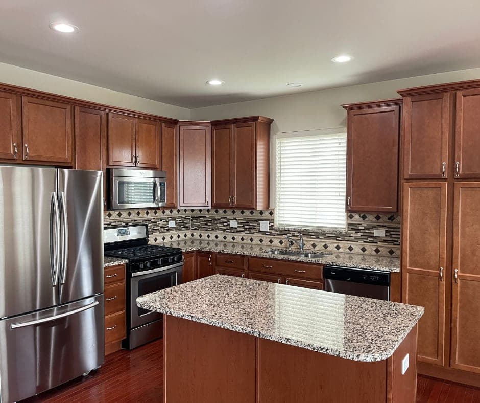 Clean modern kitchen with granite island after professional cleaning in Plainfield IL